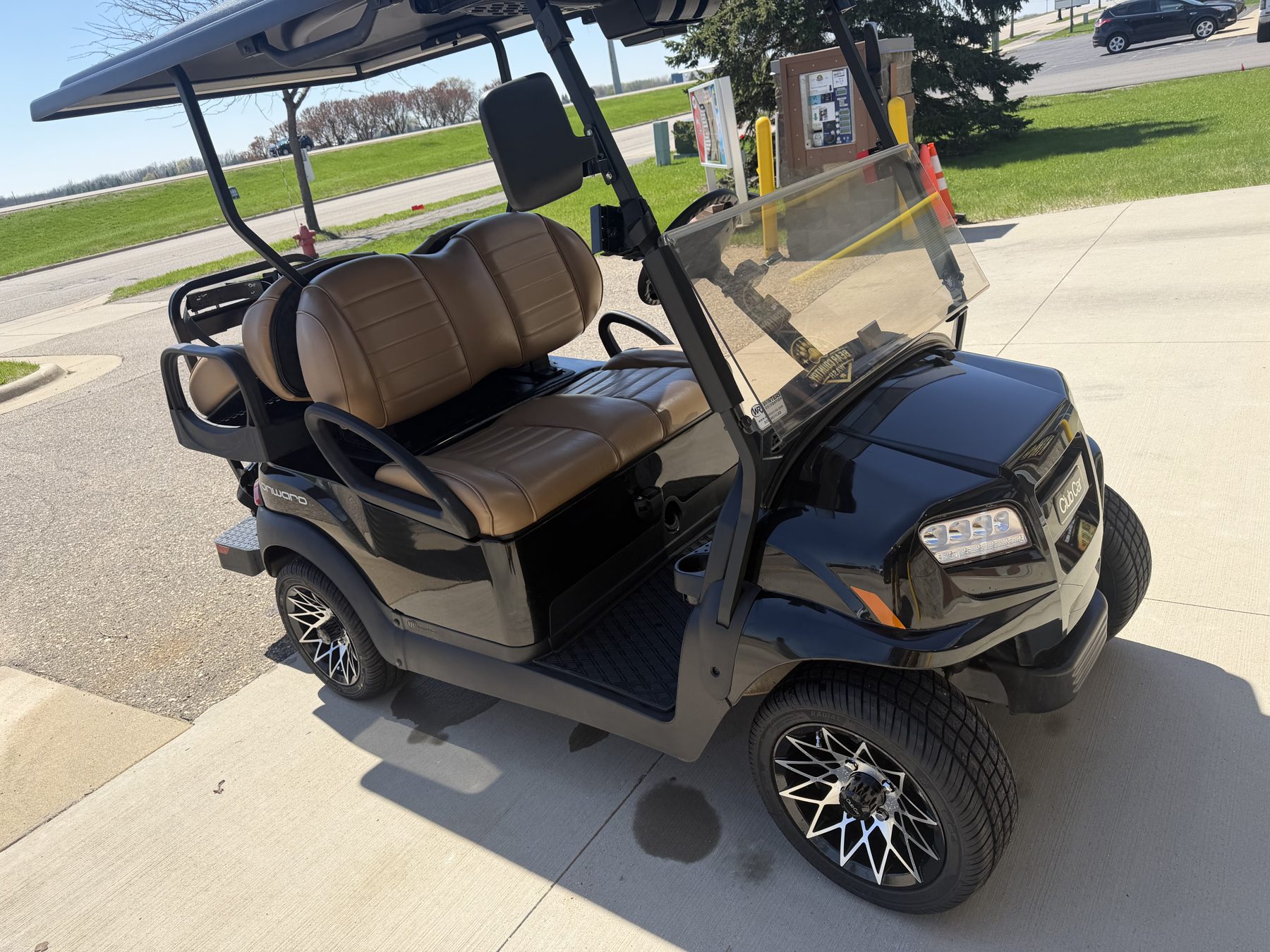 Detailed golf cart parked outside Bear Country Wash in Byron, MN