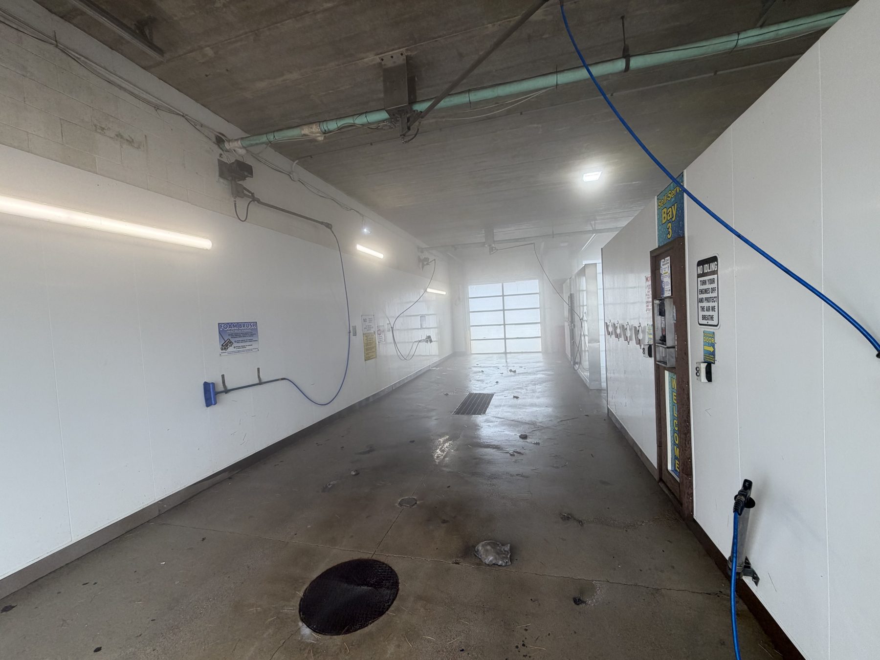 Self-serve wash bay hallway with Bay 3 signage